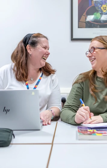 A cheerful moment between lecturer and student at Glasgow Kelvin College, showcasing supportive relationships and engaging one-to-one learning. A cheerful moment between lecturer and student at Glasgow Kelvin College, showcasing supportive relationships and engaging one-to-one learning.